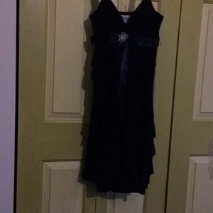 Black flowing layers dress. Gorgeous diamond pin .